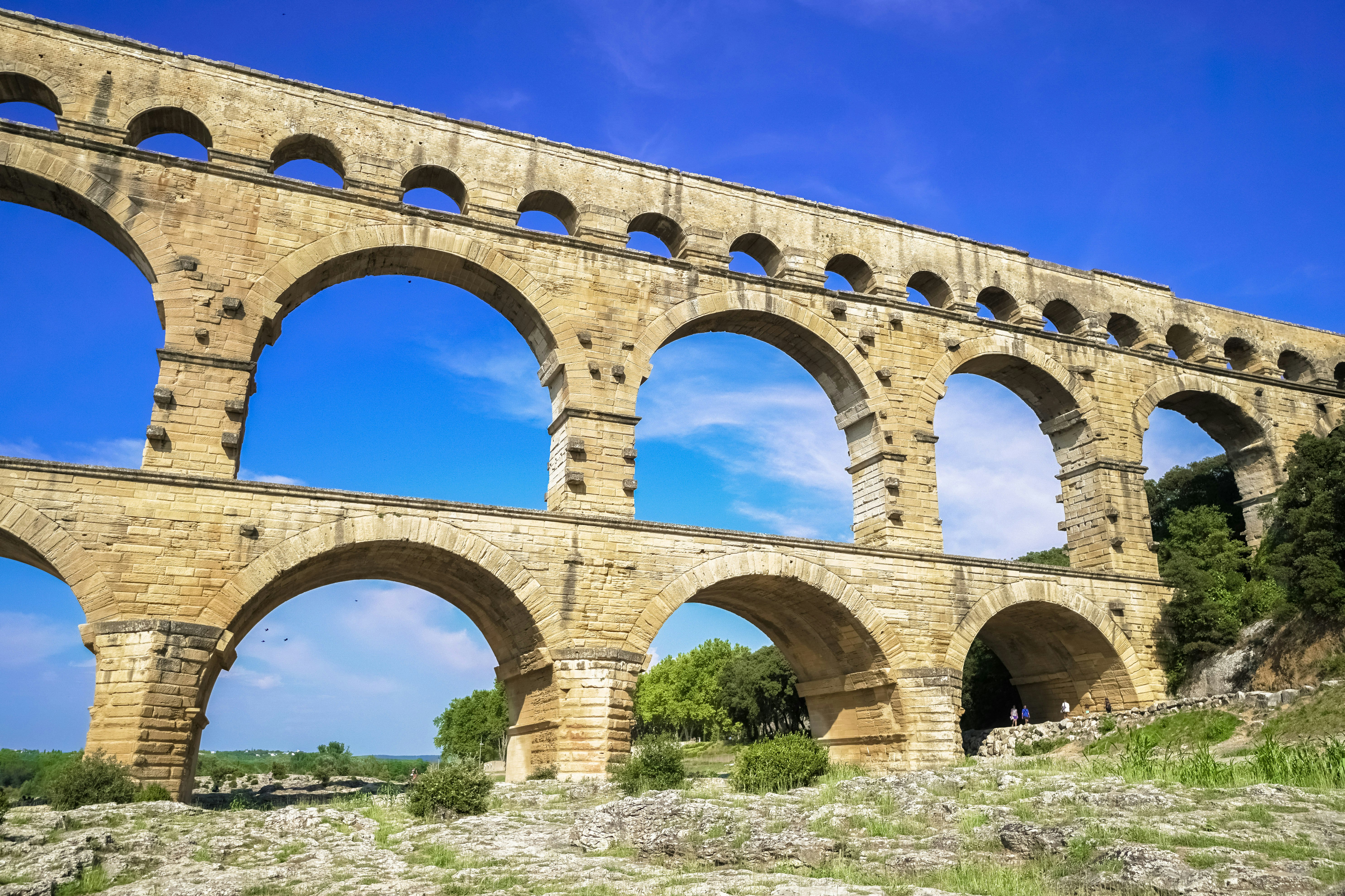 brown concrete bridge under blue sky during daytime